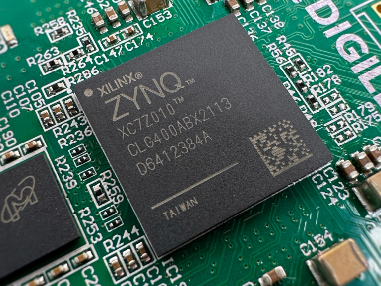 A close-up photograph of the XILINX ZYNQ microchip on the ZYBO Development Board.
